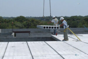 Workmen on roof constructing concrete 